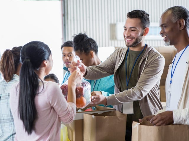 Person volunteering at a food bank as part of their recovery journey